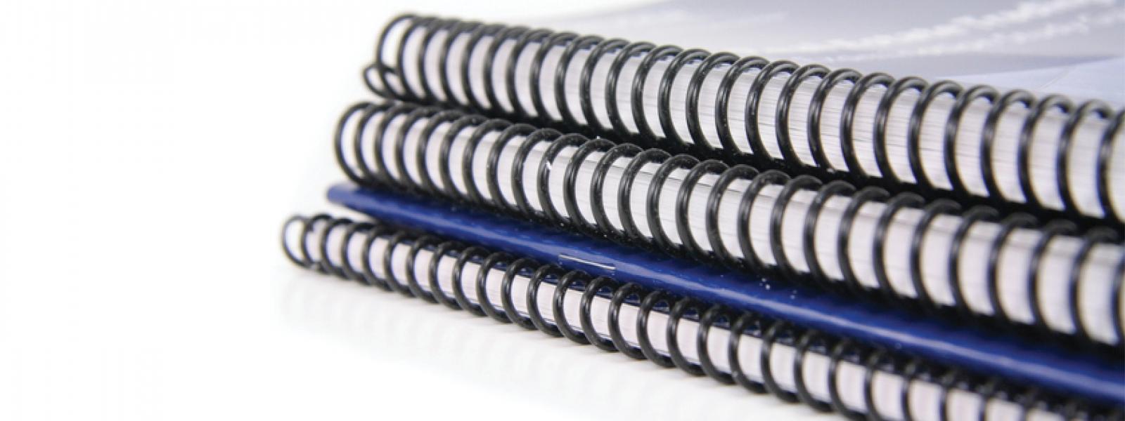 Image of stacked, spiral-bound notebooks